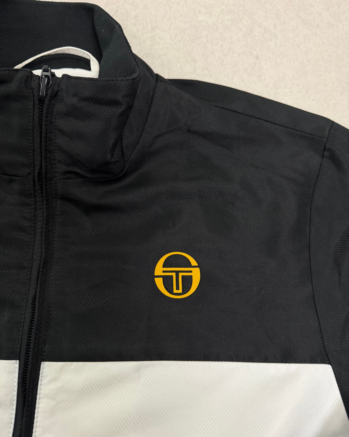Sergio Tacchini Trainingsjacke Schwarz-Weiß mit gelbem Logo – Detail